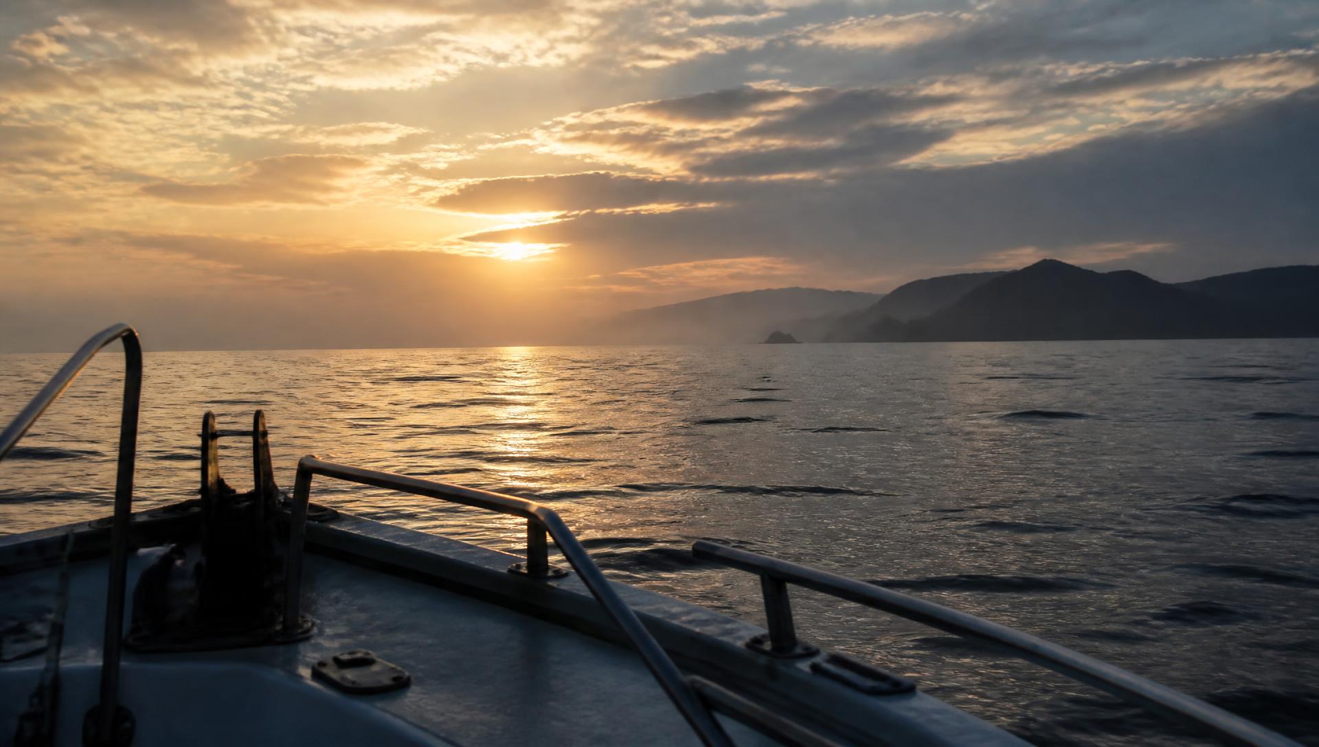 Calm Pacific water seen from a boat at first light